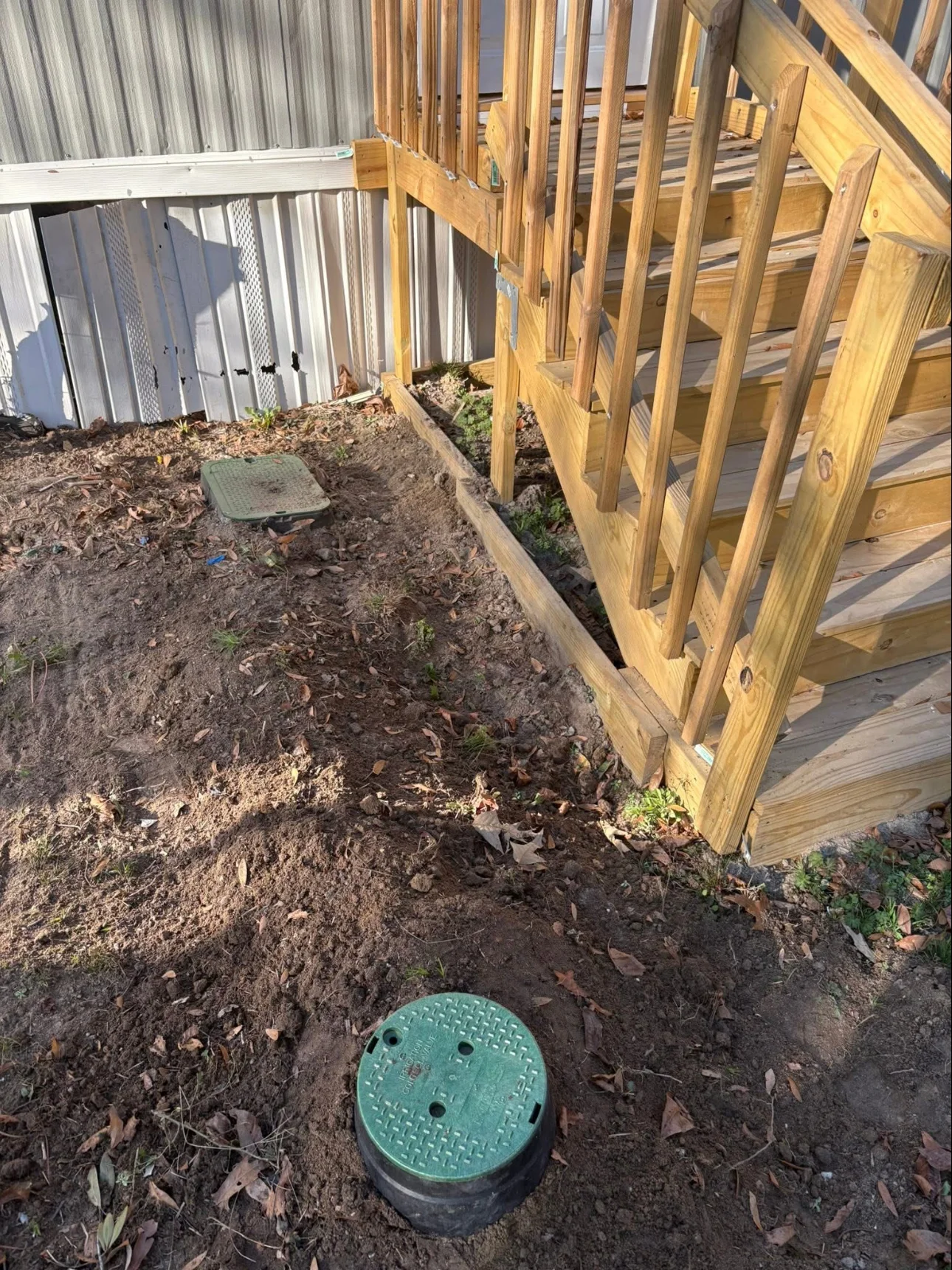 Drainage connections beside a deck